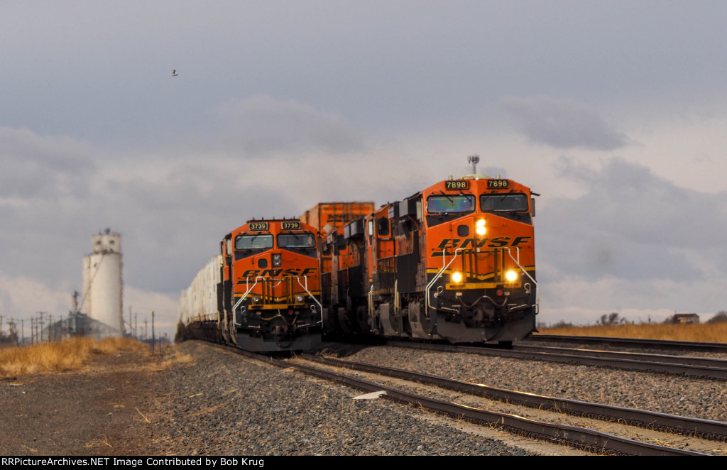 BNSF 7898 leads EB stacks passing a train led by BNSF 3739 